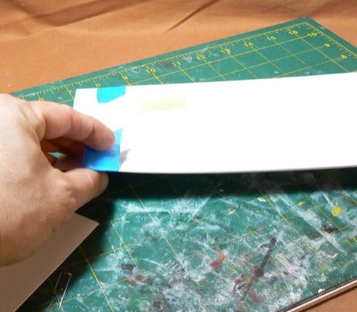 Photograph of taping Bristol Board to the 
corrugated HO scale styrene roofing former sheet