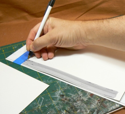 Photograph of marking Bristol Board using a 
ballpoint pen to make the HO scale metal roofing