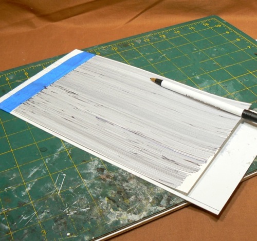 Photograph of Bristol Board marked using a
 ballpoint pen to make the HO scale metal roofing