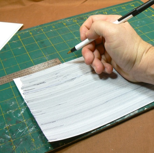 Photograph of marking Bristol Board using a
 ballpoint pen to make the HO scale metal roofing