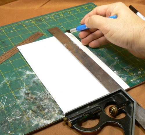 Photograph of cutting out strips of HO scale
 corrugated roofing