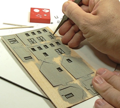 Applying trim to doors for the Curtis Bros Plumbing Supply Model railroad Kit.