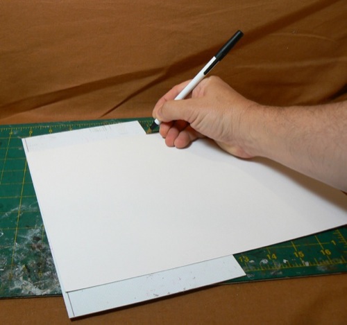 Photograph of using corrugated styrene sheet
 to measure Bristol board