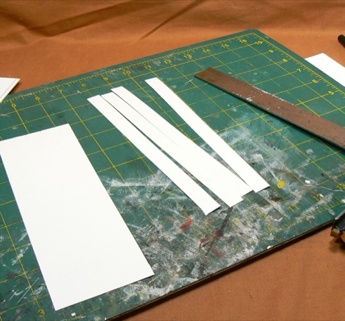 Photograph of cutting out strips of HO scale
 corrugated roofing