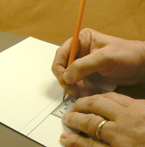 Photograph of using a scale card to mark of the width of the joists for the Z-scale 
loading dock jig