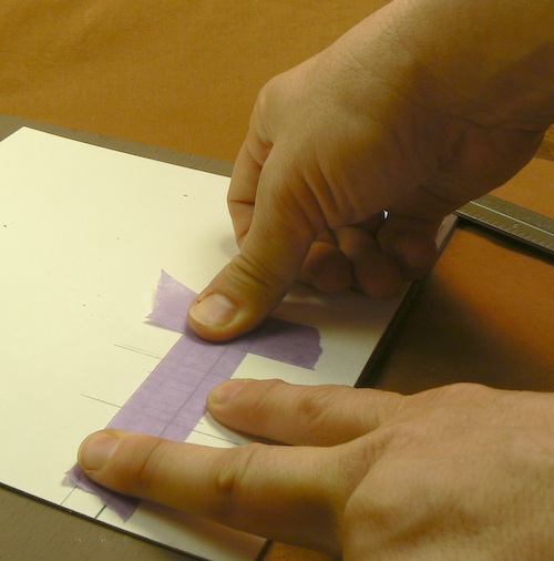 Photograph of setting purple painter's tape into place over the guidelines for the 
Z-scale loading dock jig.