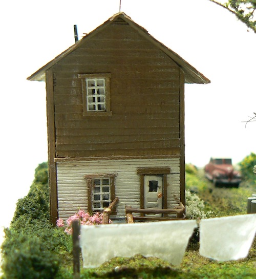 Photograph of 
window screen windows in a Z-scale scratchbuilt model Sears kit house structure